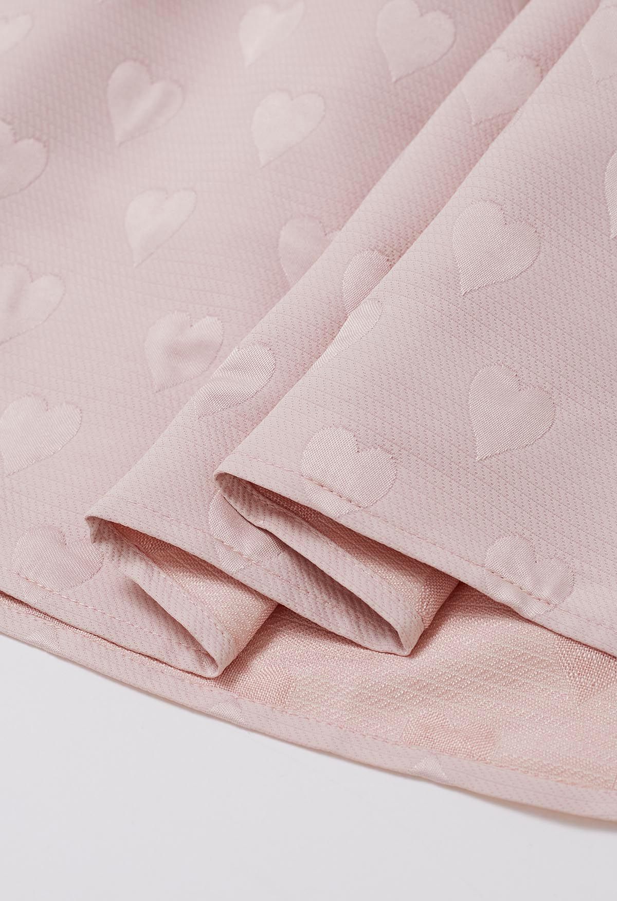 Falda midi de vuelo plisada de jacquard con corazón en relieve en rosa claro