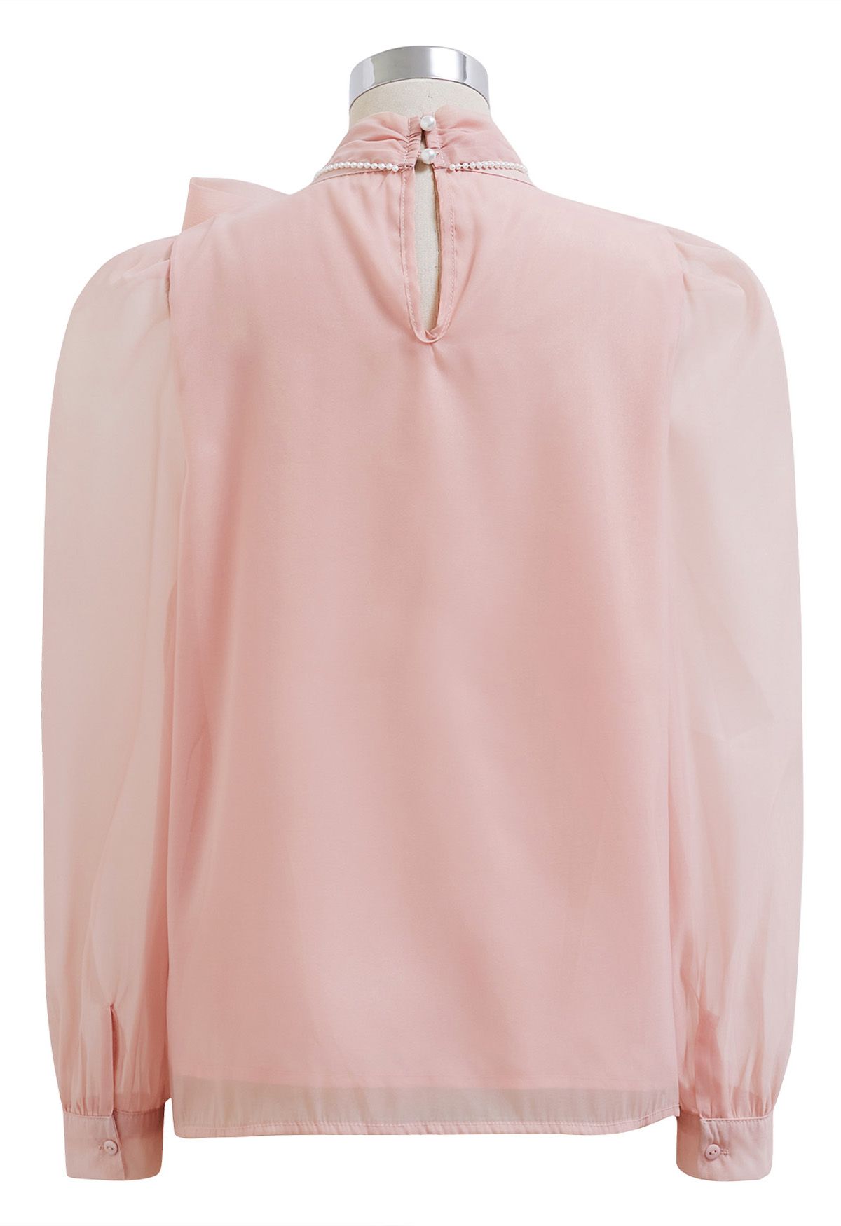 Camisa de manga abullonada con lazo nacarado en rosa