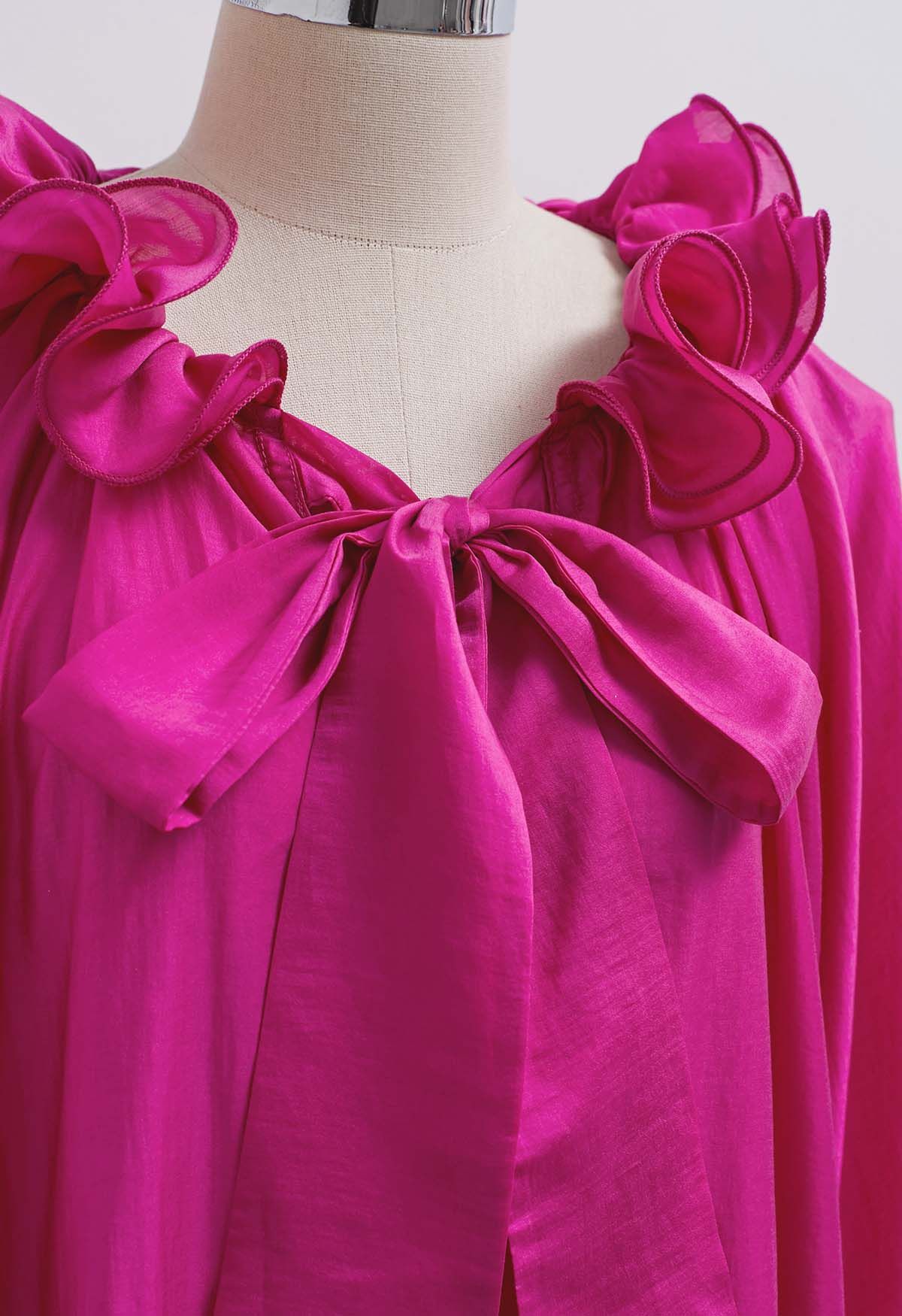 Blusa Dolly con escote con volantes escalonados, mangas farol y lazo en color magenta