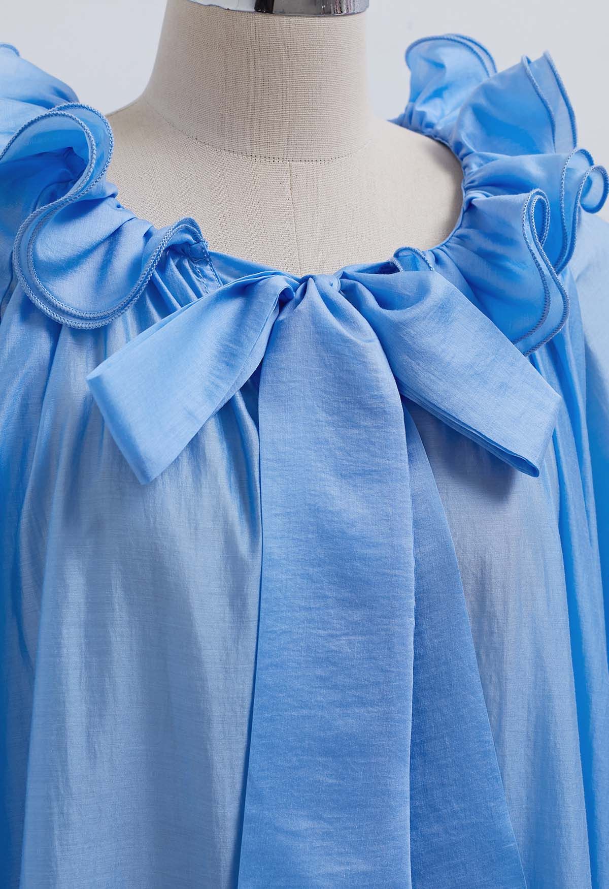 Blusa Dolly con escote con volantes escalonados, mangas farol y lazo en azul