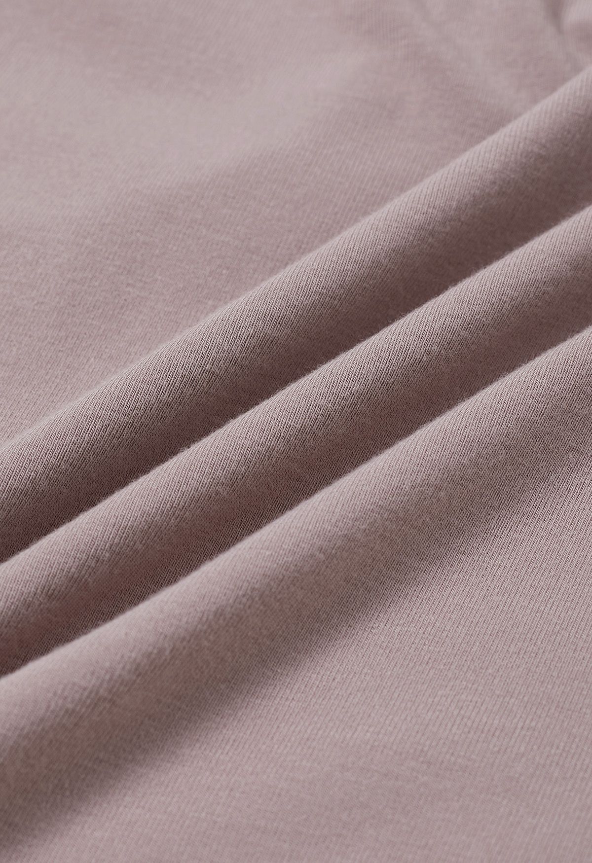Top de algodón suave con nudo lateral en rosa polvoriento