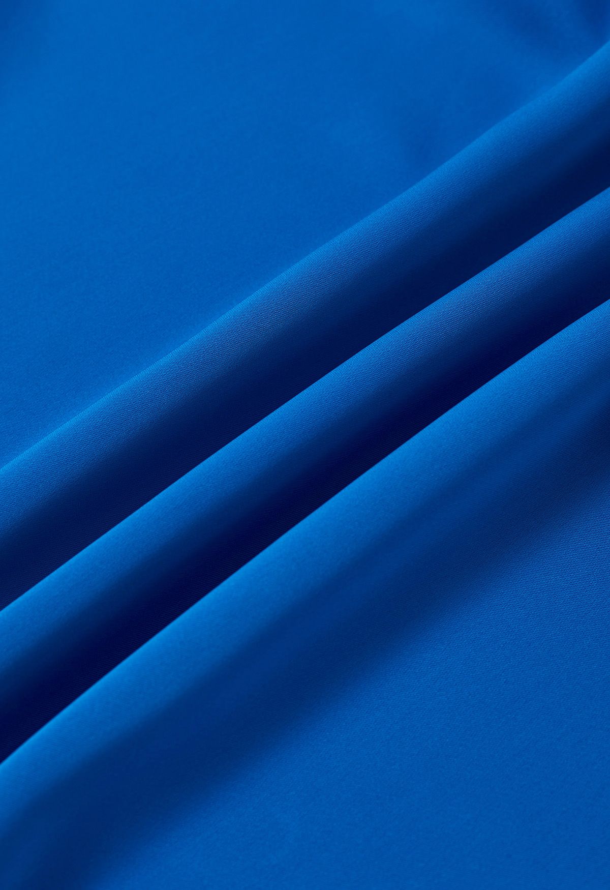 Top asimétrico de manga larga de satén fruncido en azul