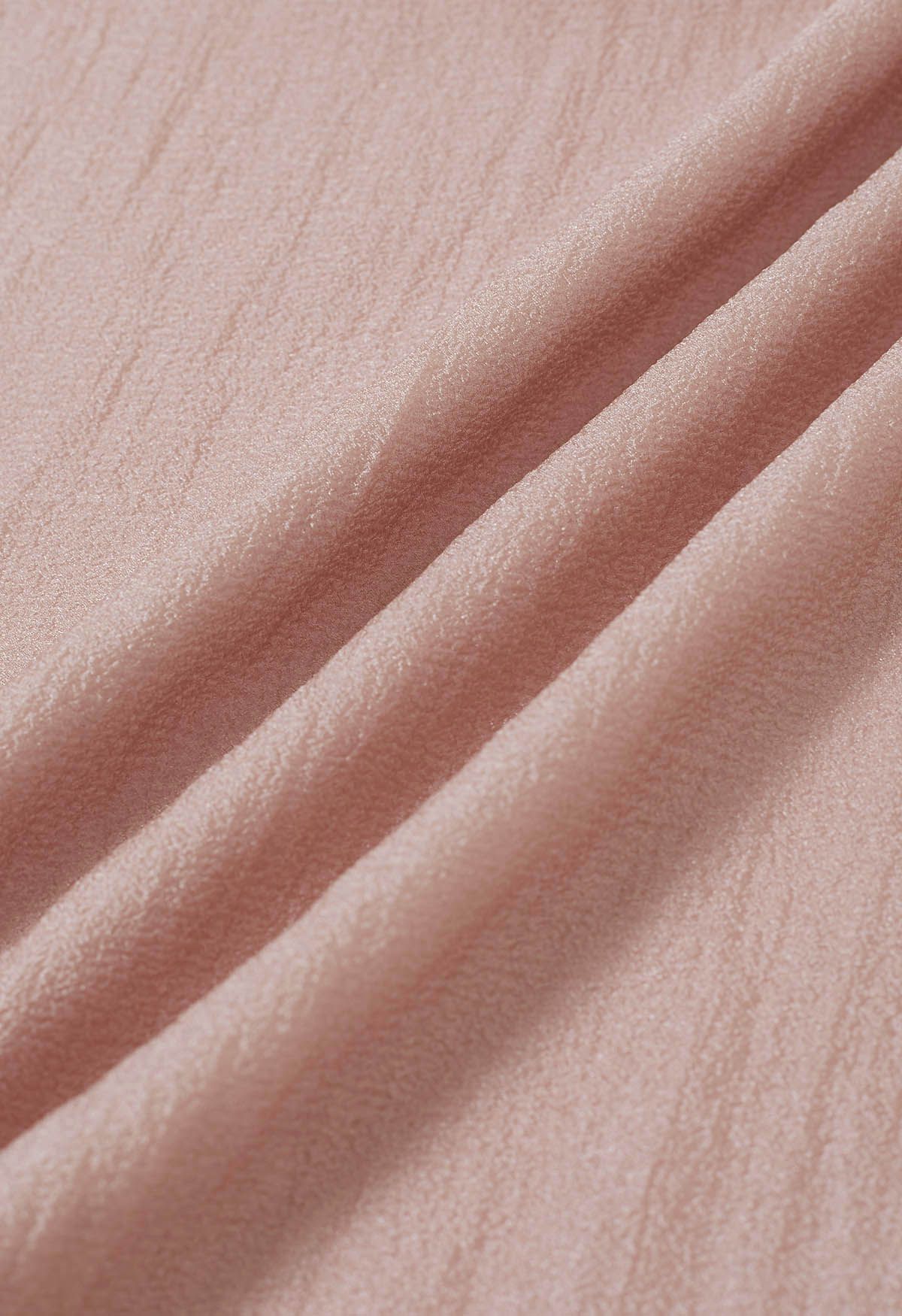 Top transparente con lazo lateral anudado en rosa