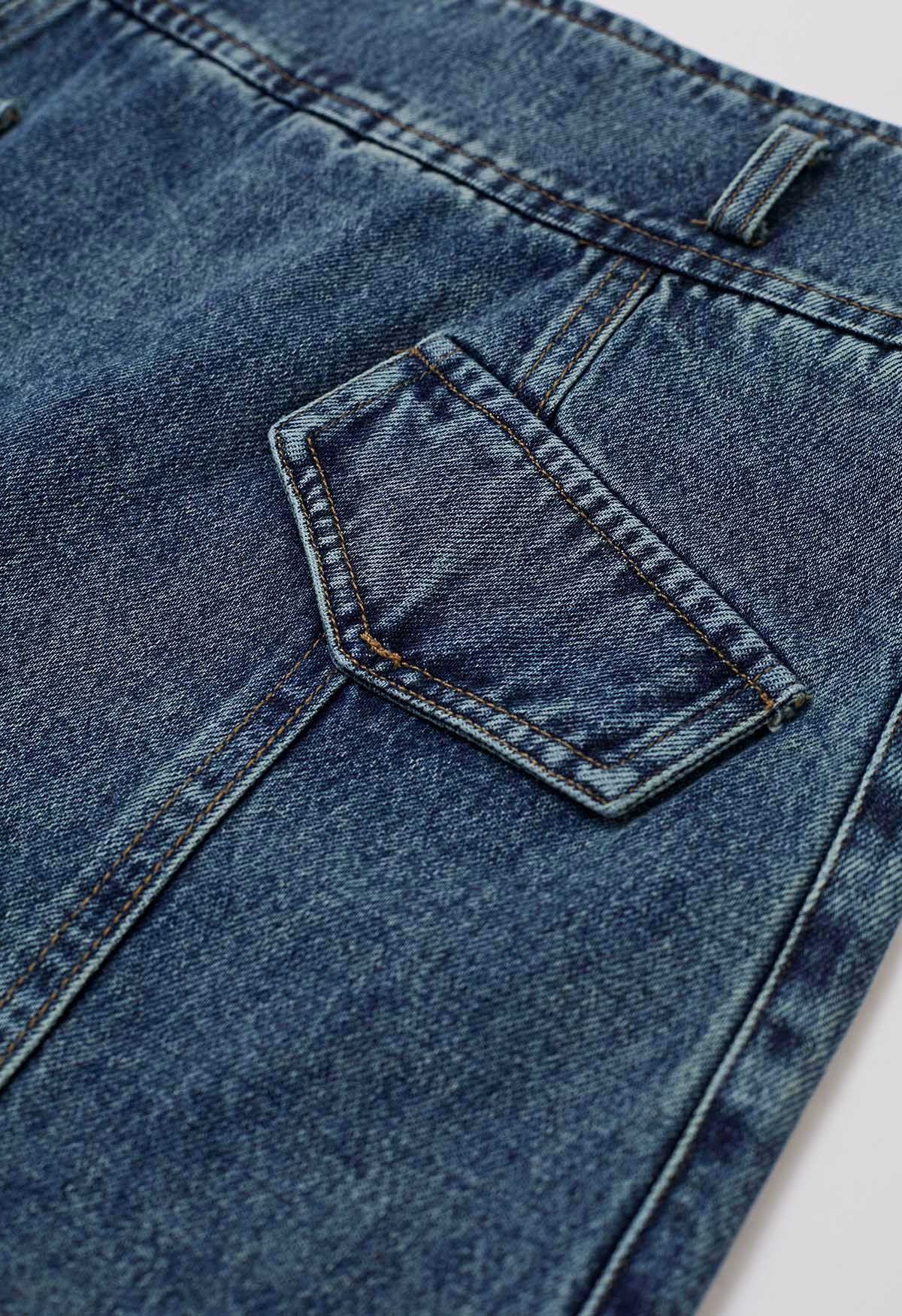 Falda pantalón vaquera con cinturón y bolsillos falsos con solapa en azul