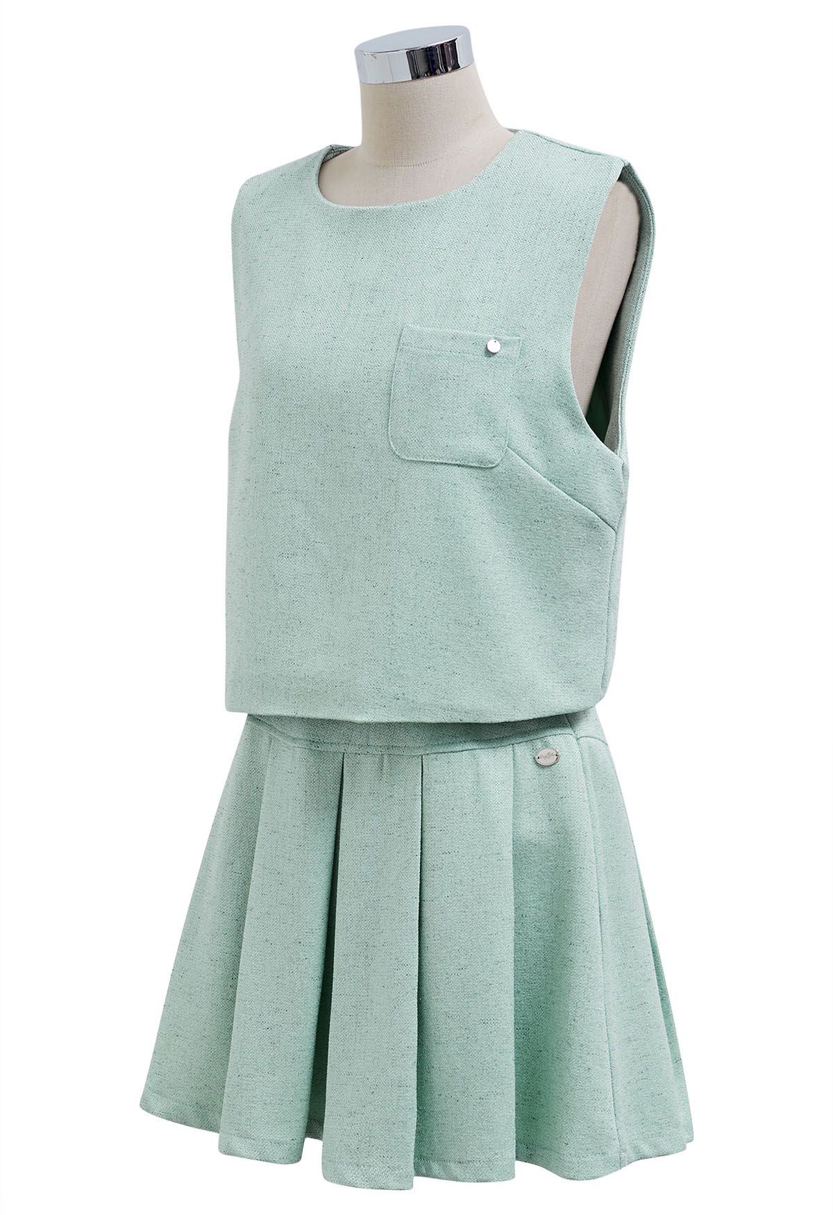 Conjunto elegante de top sin mangas de tweed y minifalda plisada en color menta