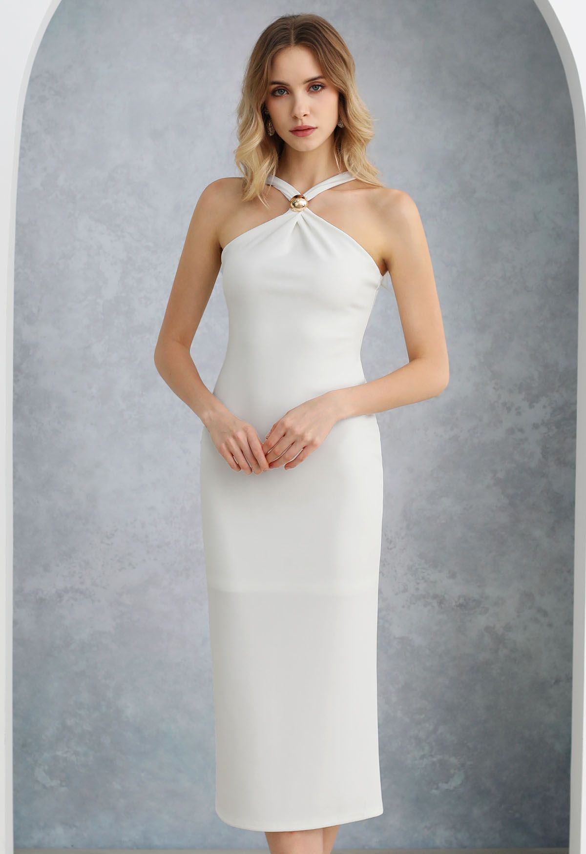 Vestido tubo con cuello halter y ribete de cuentas doradas en blanco