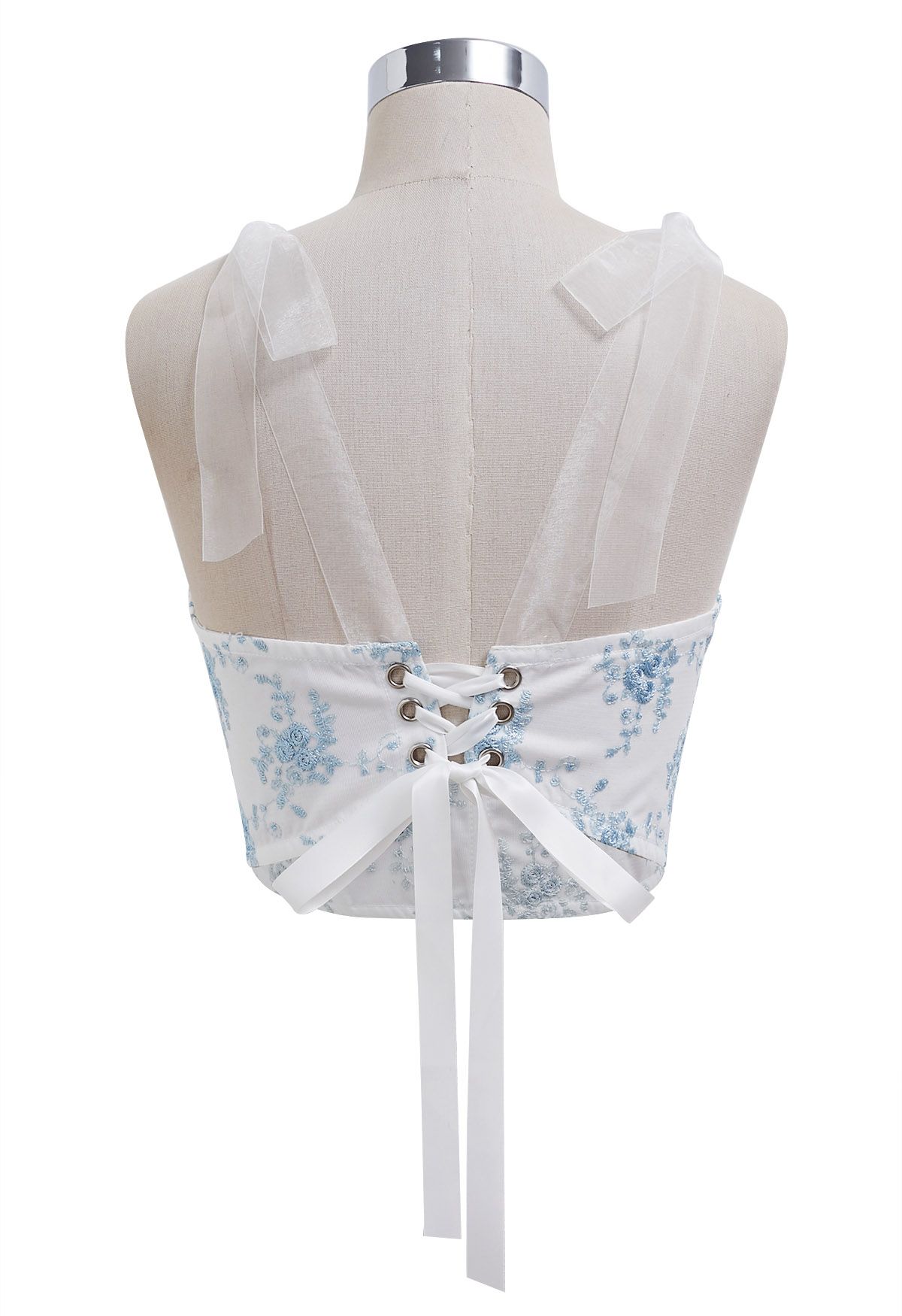 Top tipo bustier con tirantes y bordado floral azul en blanco