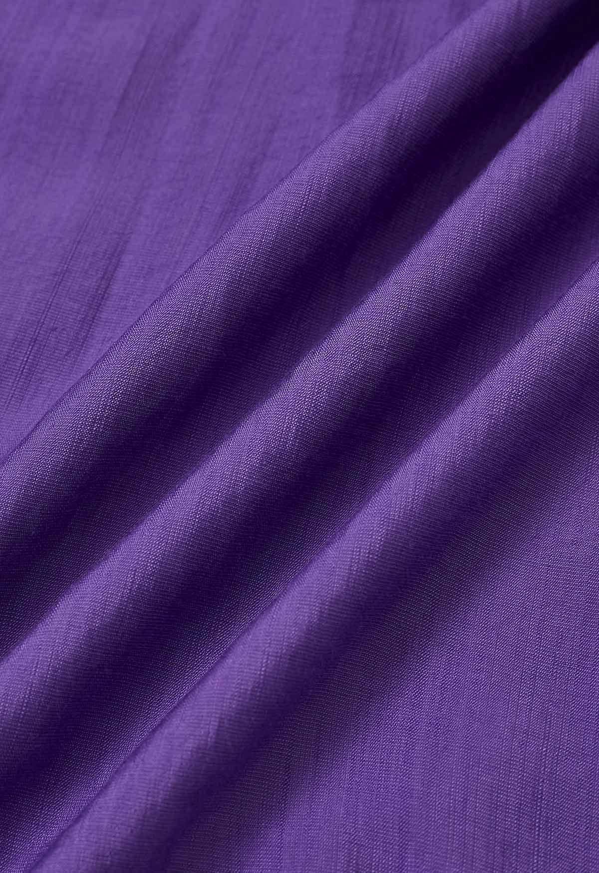 Vestido midi asimétrico con volantes y botones en morado