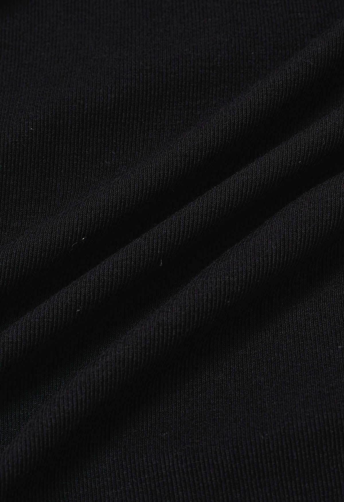 Blusa con puños con volantes y lazo lateral en color negro