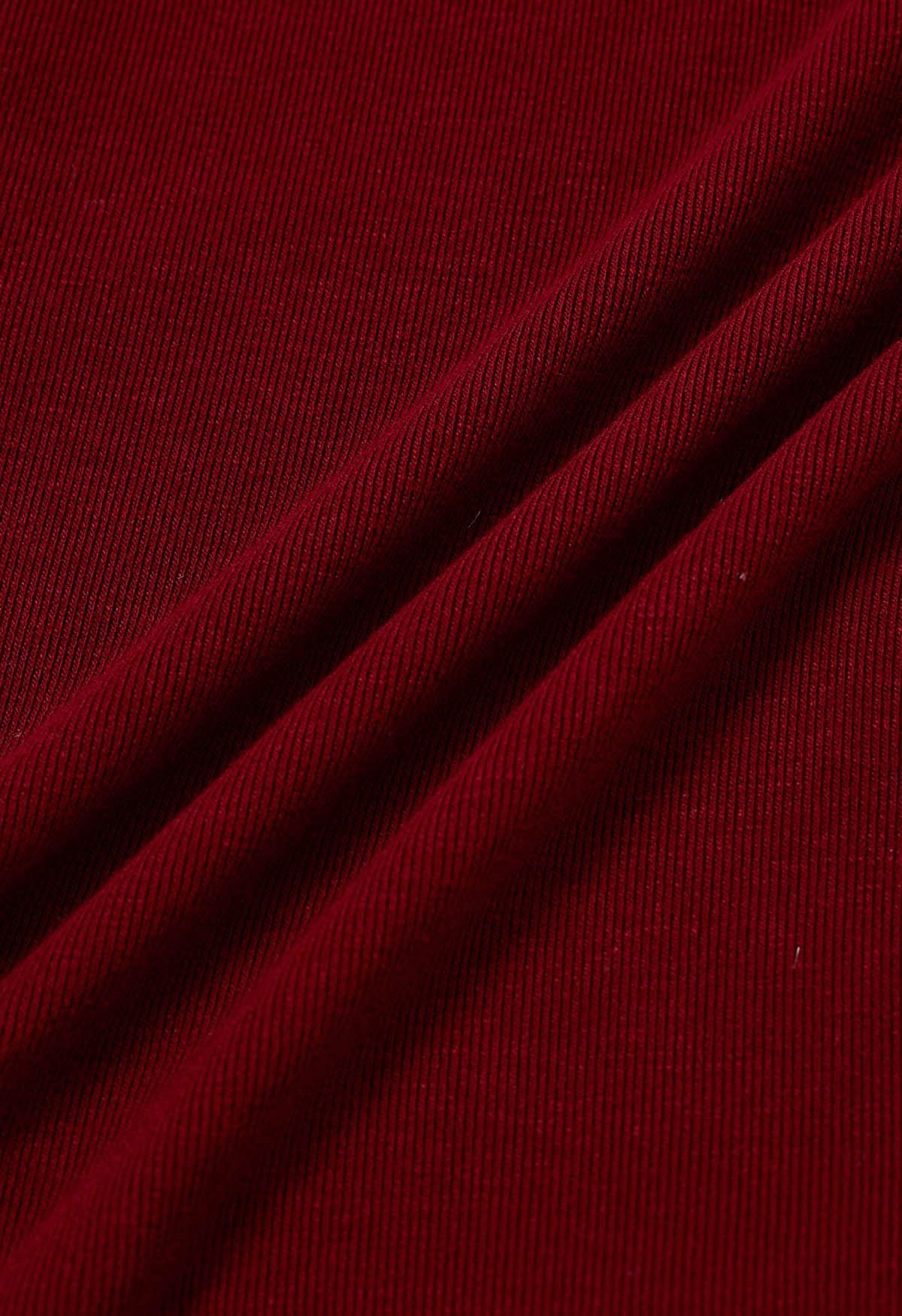 Blusa con puños con volantes y lazo lateral en rojo