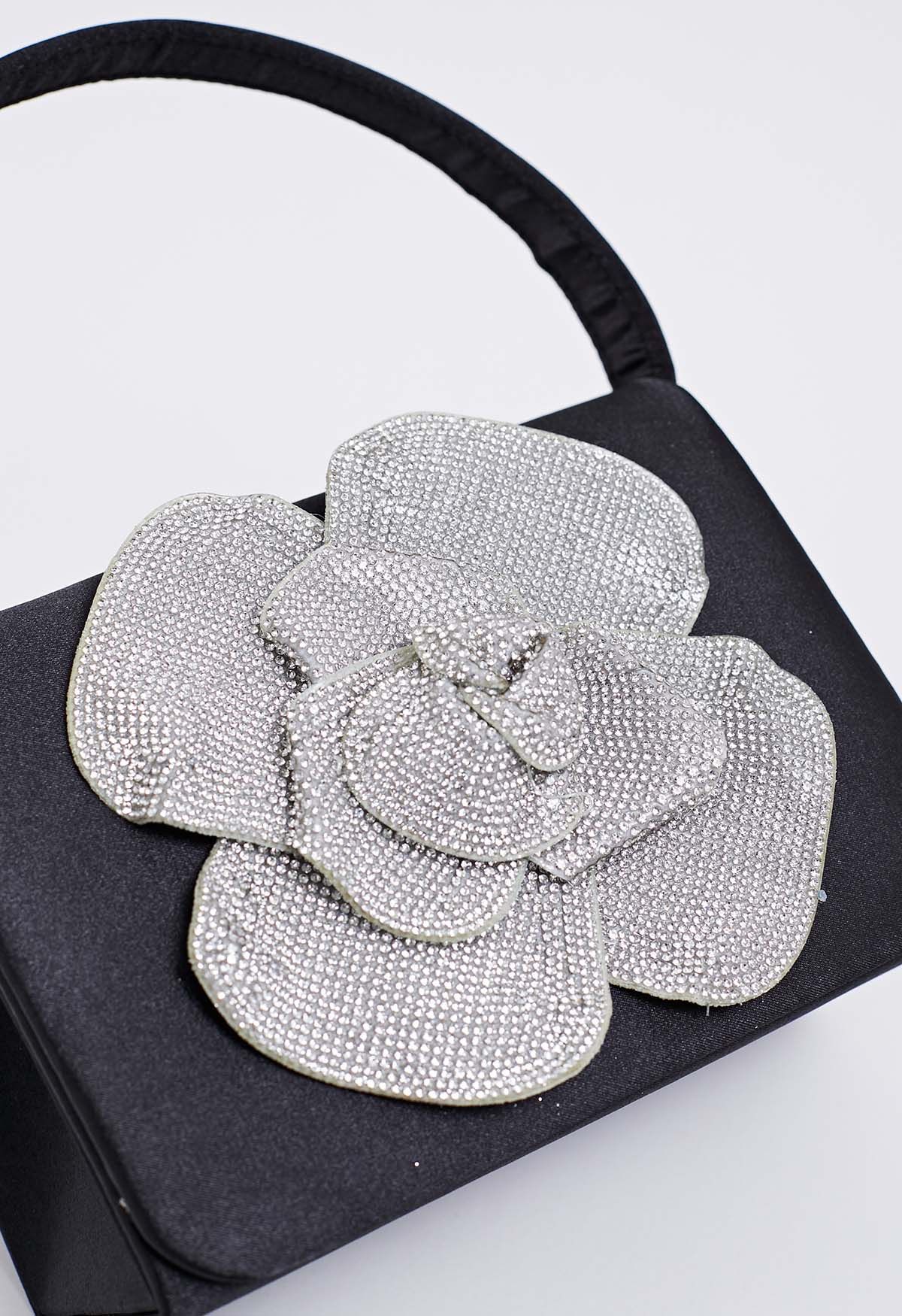 Bolso de mano de satén adornado con rosas radiantes en color negro