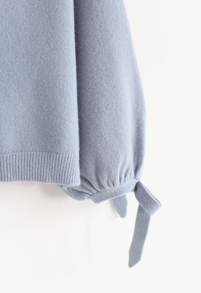 Suéter de punto Bowknot de suavidad silenciada en azul polvoriento