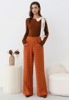 Pantalones rectos con botones y estampado de cuadrícula en color naranja