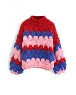 Suéter grueso tejido a mano con cuello alto con bloques de color en rojo