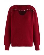 Suéter de punto con escote de perlas recortadas en rojo