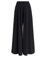 Pantalones de pernera ancha con pliegues en negro Fanciful