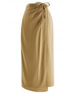 Falda midi de satén con solapa asimétrica y cintura anudada en camel
