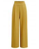 Pantalones rectos con cintura plisada en amarillo
