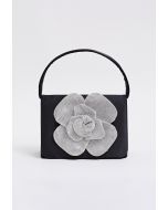 Bolso de mano de satén adornado con rosas radiantes en color negro